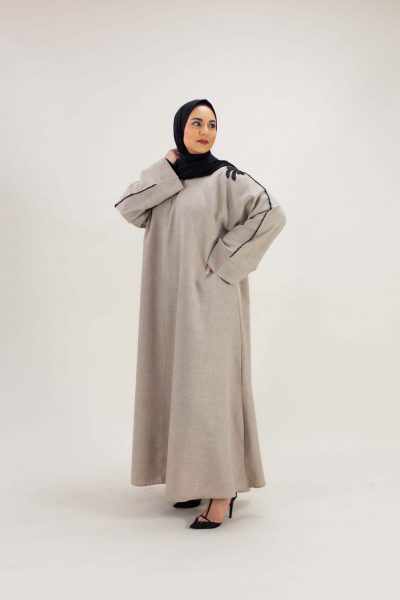 Luxury abaya brought to you by Arabian Garments. Grace meets contrast in the Dusk Elegance abaya, a timeless blend of soft cream and bold black detailing. This abaya features delicate accent and is perfect for both day and evening wear. Its lightweight fabric ensures comfort whilst exuding understated luxury.